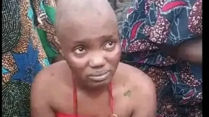 The TikToker during the traditional cleansing at the Oloolu compound
